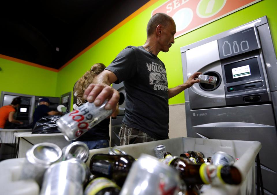 A man turns in bottles at a redemption center in Oregon.
