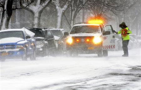 An AAA emergency technician assists a motorist on Bidwell Avenue in Buffalo, New York January 7, 2014. REUTERS/Don Heupel