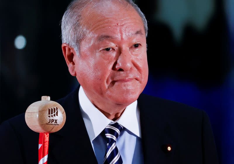 Japan's Finance Minister Shunichi Suzuki prepares to ring a bell during the New Year ceremony marking the open of trading in 2022 at the Tokyo Stock Exchange in Tokyo