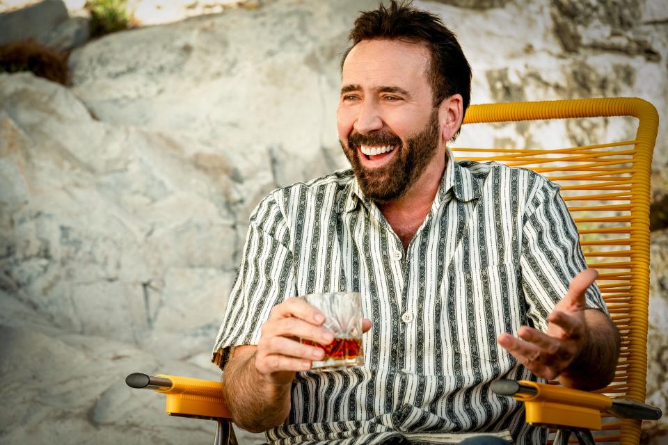 Nick Cage (Nicolas Cage) enjoys a cocktail in Spain in meta action comedy "The Unbearable Weight of Massive Talent."