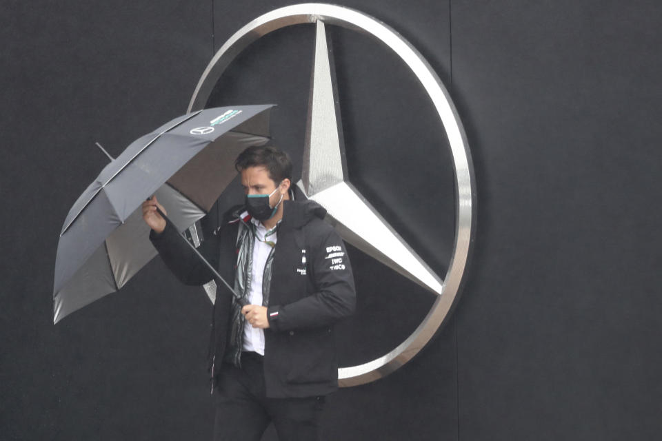 Mercedes team principal Toto Wolff holds the umbrella ahead of the second practice session for the Eifel Formula One Grand Prix at the Nuerburgring racetrack in Nuerburg, Germany, Friday, Oct. 9, 2020. The Germany F1 Grand Prix will be held on Sunday. (AP Photo/Matthias Schrader, Pool)