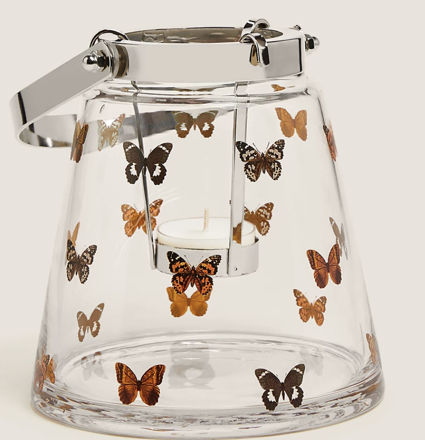 A see-through canister for tealights with prints of Butterflies 