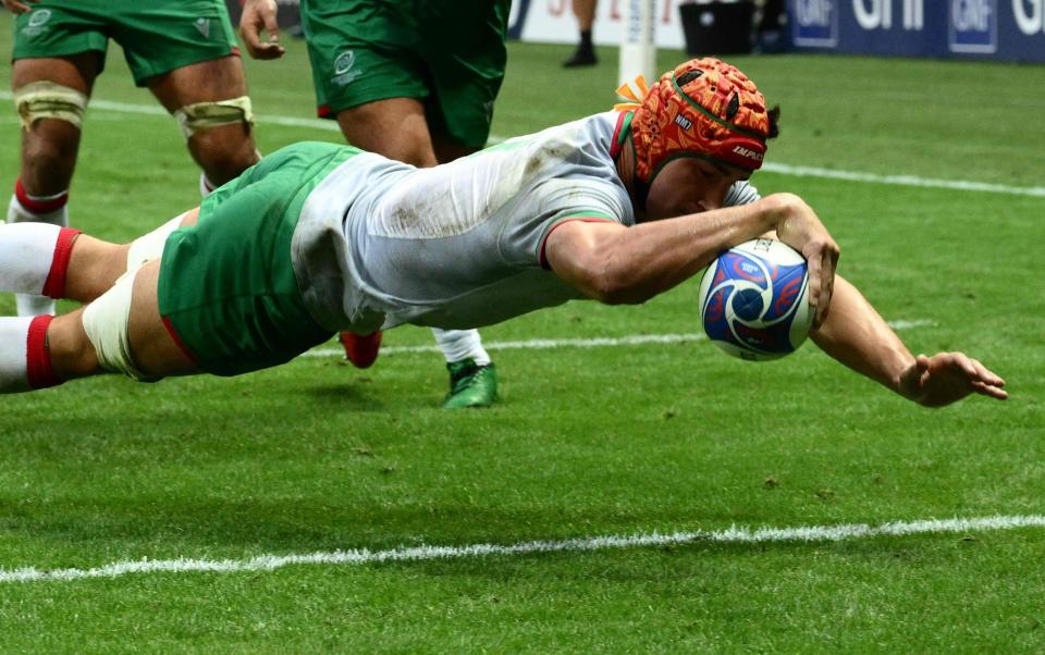 Portugal flanker Nicolas Martins dives over the line to score a try