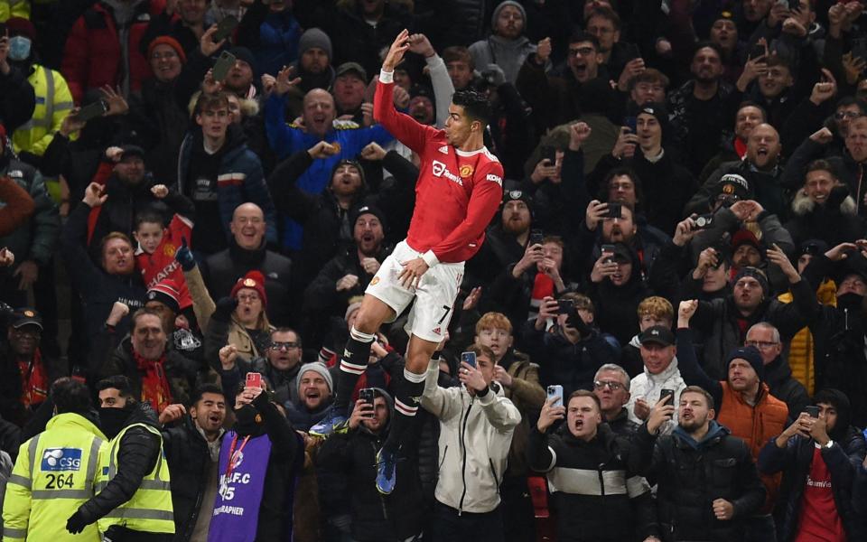 Manchester United's Cristiano Ronaldo celebrates after scoring their third goal from the penalty spot during the English Premier League football match between Manchester United and Arsenal at Old Trafford in Manchester, north west England, on December 2, 2021. - GETTY IMAGES