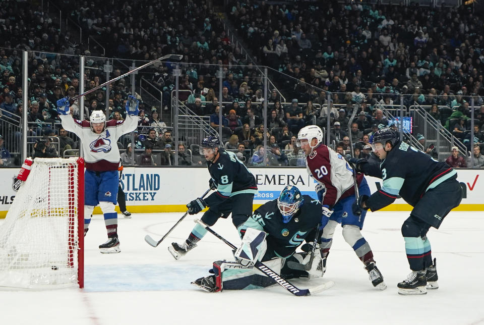 Colorado Avalanche center Ross Colton (20) watches his goal against Seattle Kraken goaltender Joey Daccord (35) as Avalanche right wing Mikko Rantanen, far left, reacts during the second period of an NHL hockey game, Monday, Nov. 13, 2023, in Seattle. (AP Photo/Lindsey Wasson)