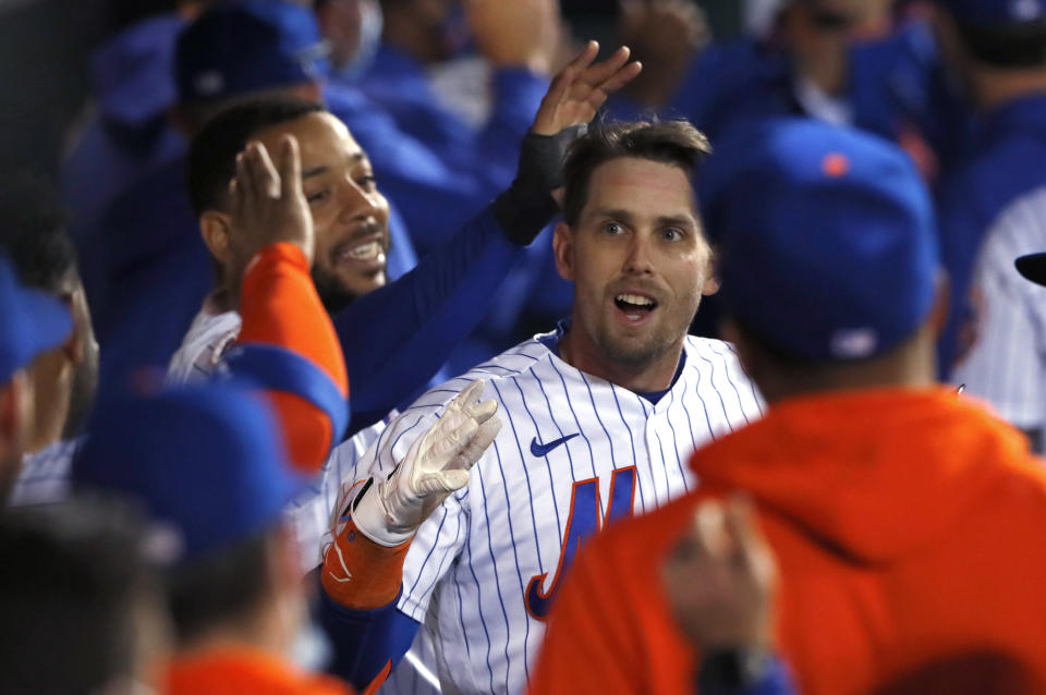 New York Mets' Jeff McNeil celebrates in the dugout after hitting a home run against the Arizona Diamondbacks during the third inning of a baseball game Saturday, May 8, 2021, in New York. (AP Photo/Noah K. Murray)
