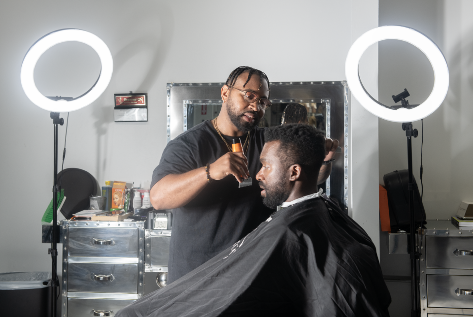Steven Scarver, a barber at Star Beauty Plus in Maple Heights, Ohio, works on Marcus Thompson's hair on Wednesday, June 26., 2024. Scarver is part of a program in Northeast Ohio that recruits barbers to serve as mental health advocates in local Black communities.