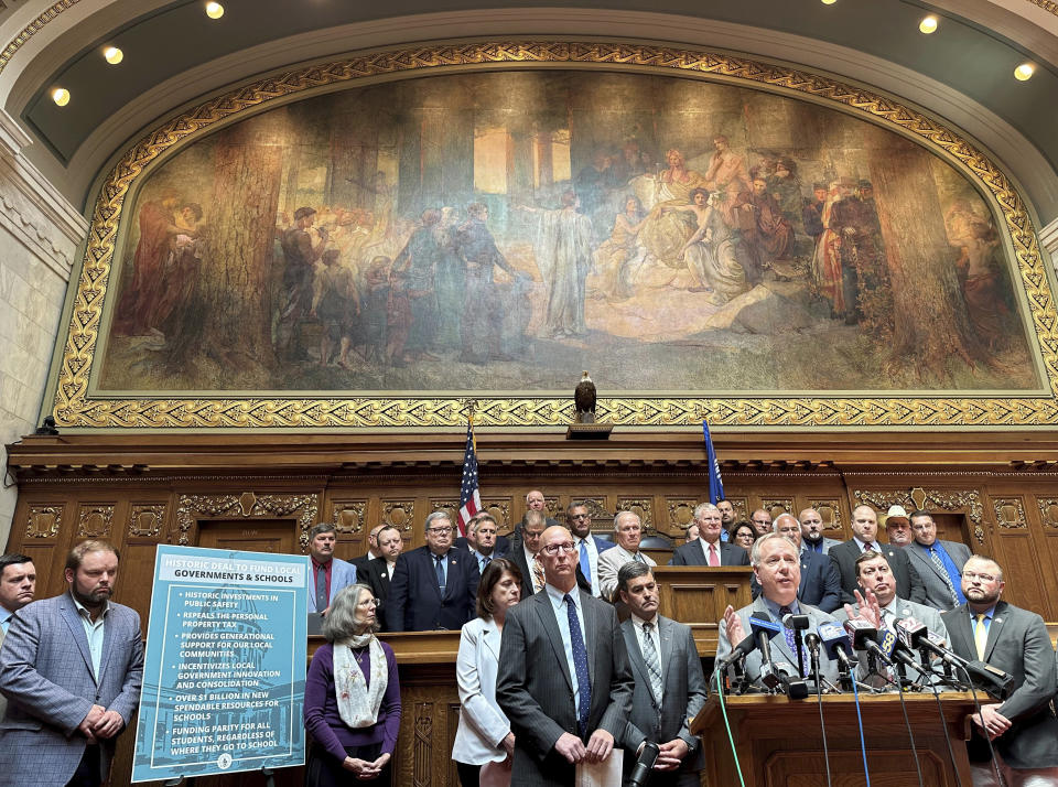 Wisconsin Republican Assembly Speaker Robin Vos, right at lecturn, is surrounded by fellow Republican lawmakers in the Assembly chamber, as he discusses details of a funding plan to save Milwaukee from bankruptcy, increase funding for local governments and bolster spending on K-12 schools, Thursday, June 8, 2023, in Madison, Wis. (AP Photo/Scott Bauer)