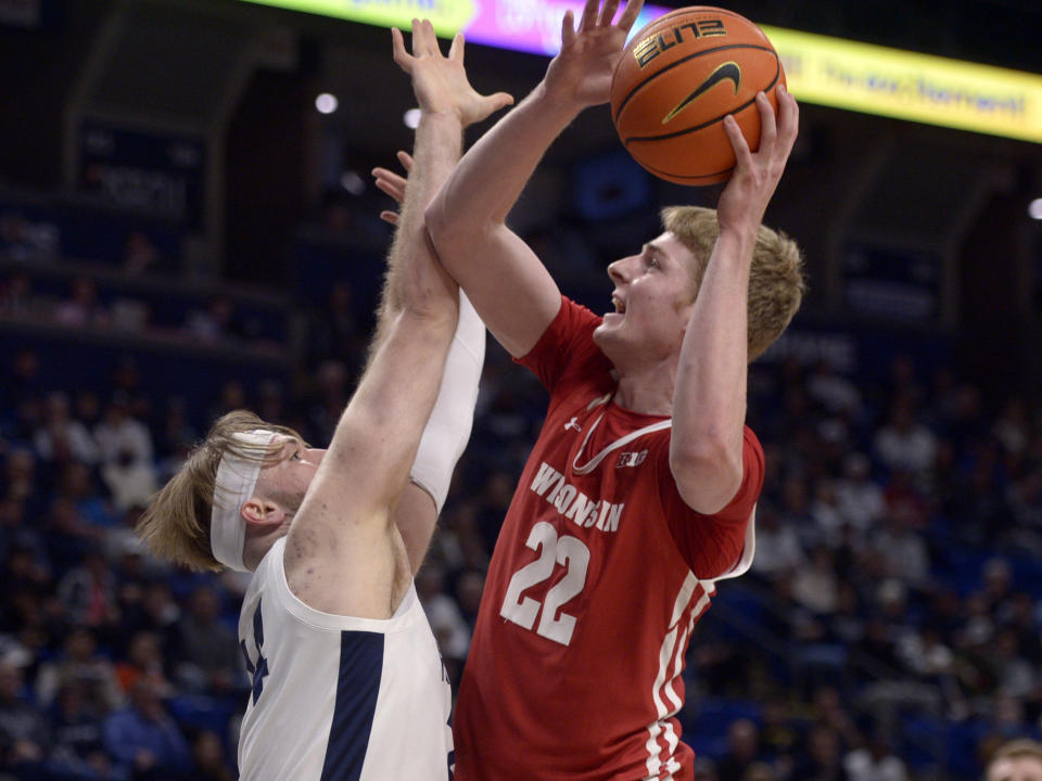 Wisconsin's Steven Crowl (22) shoots on Penn State's Michael Henn (24) during the first half of an NCAA college basketball game, Wednesday, Feb. 8, 2023, in State College, Pa. (AP Photo/Gary M. Baranec)