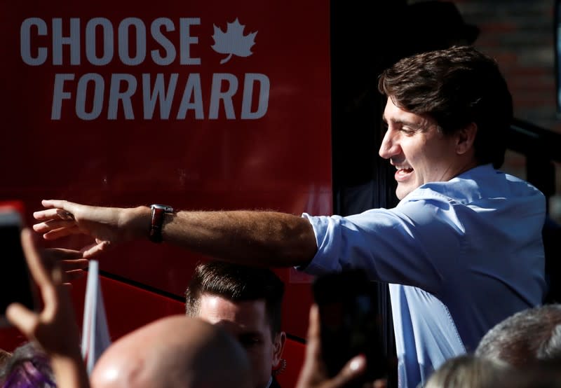 Liberal leader and Canadian Prime Minister Justin Trudeau waves after boarding his bus as he campaigns for the upcoming election, in Whitby