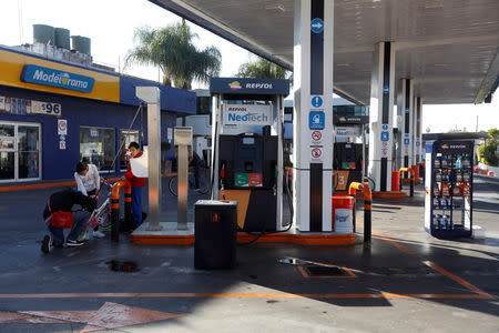 A man inflates bicycle tires at a Repsol gas station closed due shortage of fuel in Guadalajara, Mexico January 6, 2019. REUTERS/Fernando Carranza