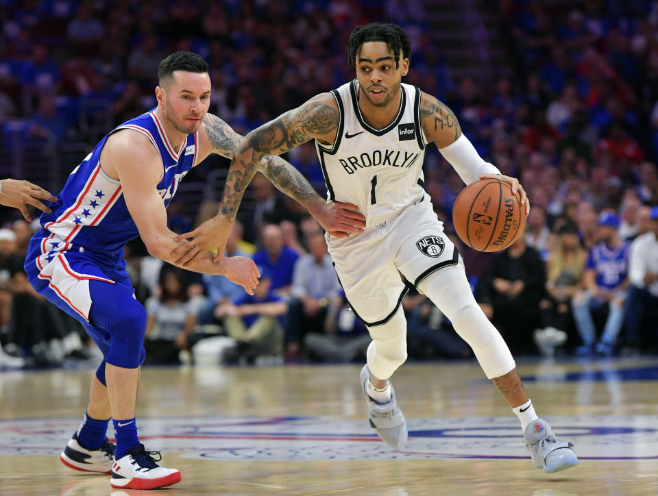 PHILADELPHIA, PA - APRIL 13: D'Angelo Russell #1 of the Brooklyn Nets drives around JJ Redick #17 of the Philadelphia 76ers in the first half during Game One of the first round of the 2019 NBA Playoff at Wells Fargo Center on April 13, 2019 in Philadelphia, Pennsylvania. NOTE TO USER: User expressly acknowledges and agrees that, by downloading and or using this photograph, User is consenting to the terms and conditions of the Getty Images License Agreement. (Photo by Drew Hallowell/Getty Images)
