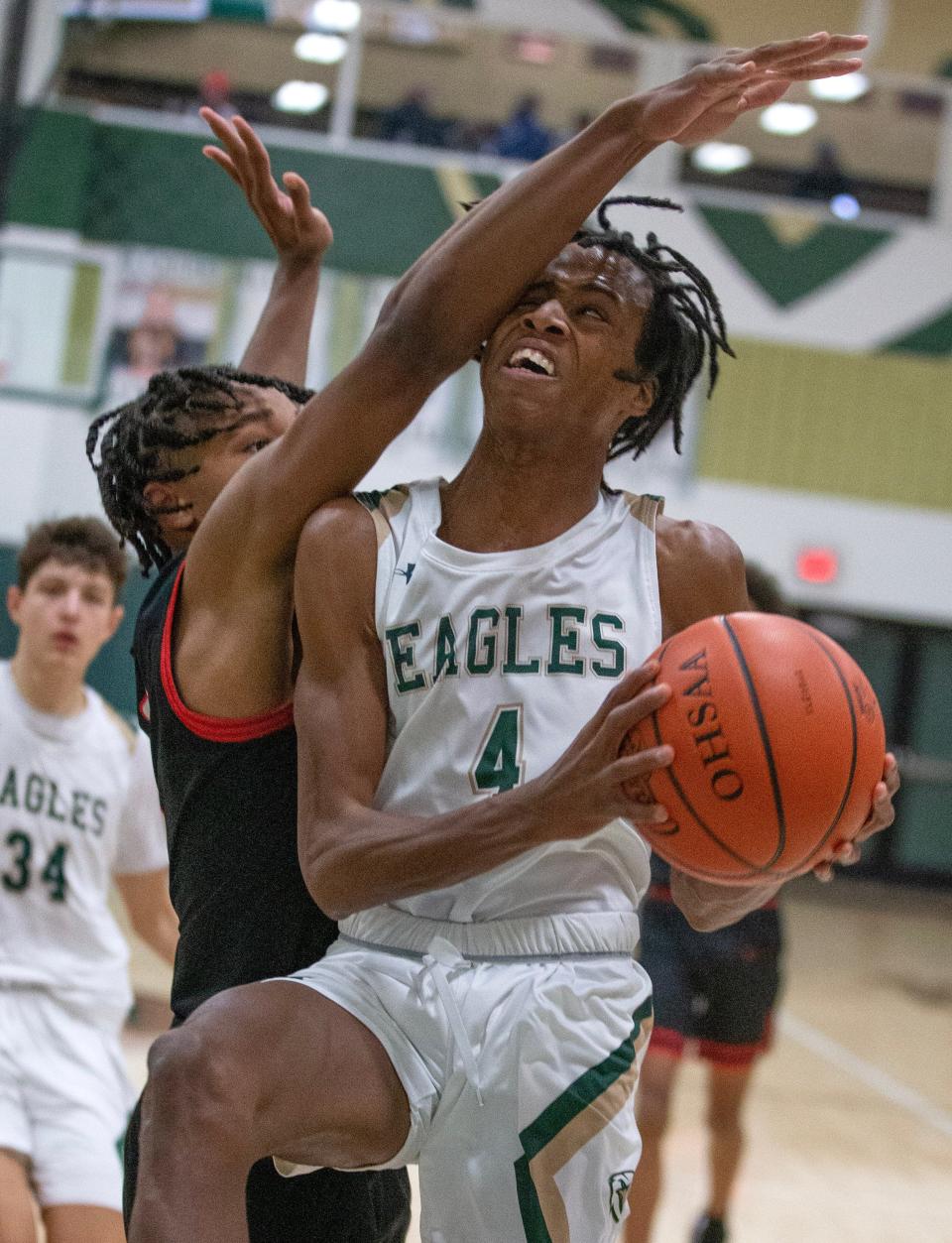 GlenOak's Jaylen McElroy draws the foul from McKinley's Dante McClellan in the second half at GlenOak Tuesday, January 24, 2023.