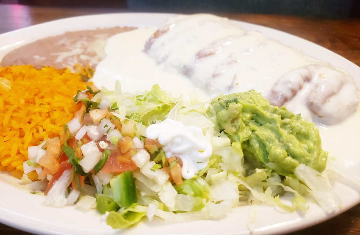 A fajita chimichanga smothered in melted cheese and served with lettuce, guacamole, rice and beans is one of the dishes at La Bonita Mexican restaurant.