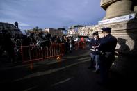 Police officers stand guard as media wait outside the Italian Supreme Court in Rome on March 27, 2015