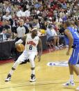 In this photo provided by the Las Vegas News Bureau, U.S. Olympic men's basketball team member LeBron James looks to pass against the Dominican Republic during an exhibition game in Las Vegas on Thursday, July 12, 2012. The United States won 113-59. (AP Photo/Las Vegas News Bureau, Brian Jones)