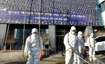 Workers from a disinfection service company sanitize a street in front of a branch of the Shincheonji Church of Jesus the Temple of the Tabernacle of the Testimony where a woman known as "Patient 31" attended a service in Daegu