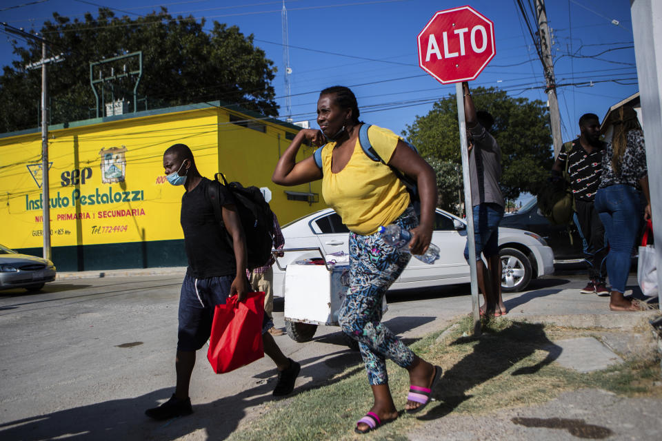 Haitian migrants walk toward the Rio Grande river to return to the migrant encampment in Del Rio, TexasFriday, Sept. 17, 2021, in Ciudad Acuña, Mexico. Haitians crossed the Rio Grande freely and in a steady stream, going back and forth between the U.S. and Mexico through knee-deep water with some parents carrying small children on their shoulders. Unable to buy supplies in the U.S., they returned briefly to Mexico for food and cardboard to settle, temporarily at least, under or near the bridge in Del Rio, a city of 35,000 that has been severely strained by migrant flows in recent months. (Marie D. De Jesús/Houston Chronicle via AP)