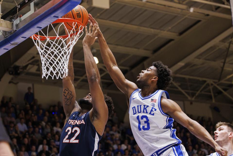 Duke's Sean Stewart (13) blocks the shot of Virginia's Jordan Minor (22) during the first half of an NCAA college basketball game in Durham, N.C., Saturday, Mar. 2, 2024. (AP Photo/Ben McKeown)