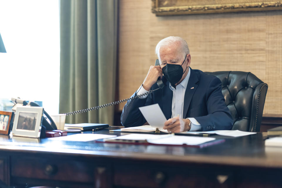 In this photo provided by The White House, President Joe Biden talks on the phone with his national security team from the Treaty Room in the residence of the White House in Washington, Friday, July 22, 2022. Biden's physician says the president's COVID-19 symptoms have improved after a full day of treatment with the anti-viral drug Paxlovid and Tylenol. (Adam Schultz/The White House via AP)