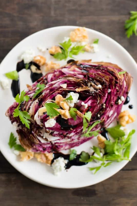 <p>Foxes Love Lemons</p><p>This Roasted Radicchio Wedge Salad is a new take on a classic restaurant dish. Radicchio is roasted until just tender, then topped with a balsamic vinegar reduction, walnuts, blue cheese and parsley.</p><p><strong>Get the recipe: <a href="https://foxeslovelemons.com/roasted-radicchio-wedge-salad/" rel="nofollow noopener" target="_blank" data-ylk="slk:Roasted Radicchio Wedge Salad;elm:context_link;itc:0;sec:content-canvas" class="link rapid-noclick-resp">Roasted Radicchio Wedge Salad</a></strong></p>