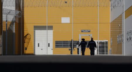 FILE PHOTO: Prison guards enter the Reau penitentiary, near Paris, September 24, 2013. REUTERS/Christian Hartmann/File Photo