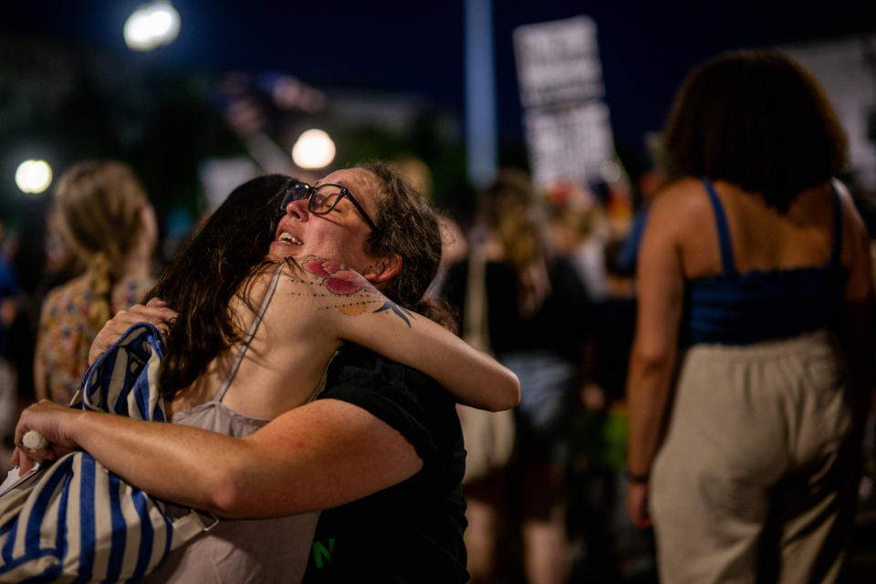 WASHINGTON, DC - JUNE 26:  Protesters embrace at a candlelight vigil in front of the U.S. Supreme Court to denounce the court's decision to end federal abortion rights protections on June 26, 2022 in Washington, DC. The Supreme Court's decision in the Dobbs v Jackson Women's Health overturned the landmark 50-year-old Roe v Wade case.  (Photo by Brandon Bell/Getty Images)