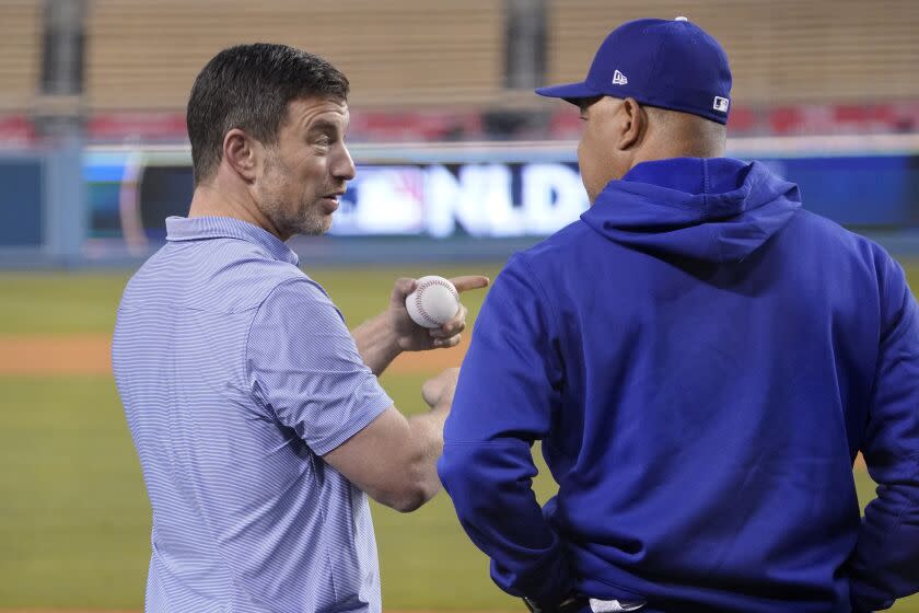Los Angeles Dodgers President of Baseball Operations Andrew Friedman, left, talks with manager Dave Roberts.