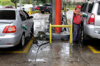 A gas station worker pumps gas into a car at a gas station of the Venezuelan state-owned oil company PDVSA in Caracas, Venezuela September 24, 2018. REUTERS/Marco Bello