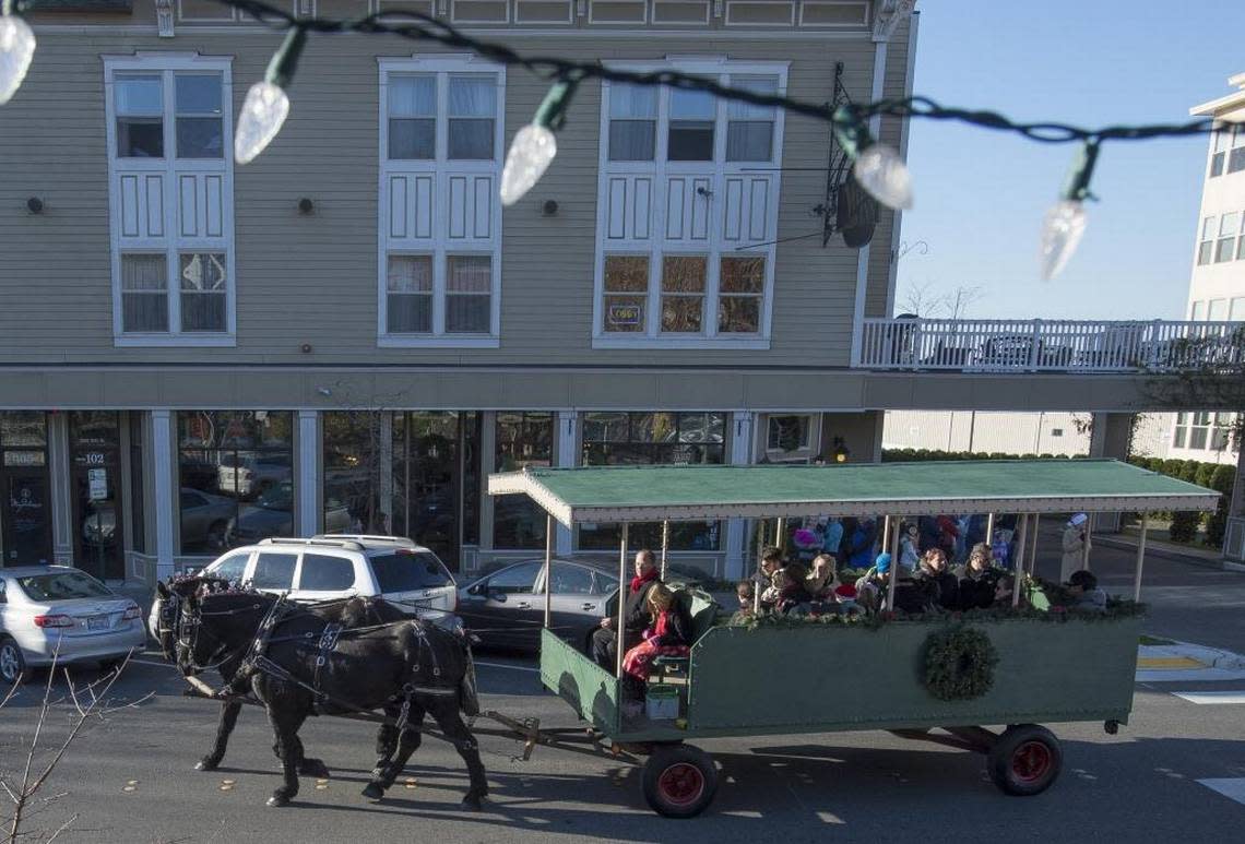 A horse-drawn wagon rolls down 10th Street outside Fairhaven Village Inn on Saturday, Nov. 28, 2015, in Bellingham.