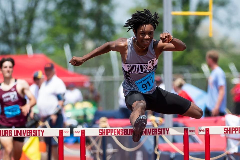 South Western's Bernard Bell leaps over the final hurdle on his way to a gold medal in the 3A 300-meter hurdles (37.69) at the PIAA District 3 Track and Field Championships at Shippensburg University Saturday, May 20, 2023.