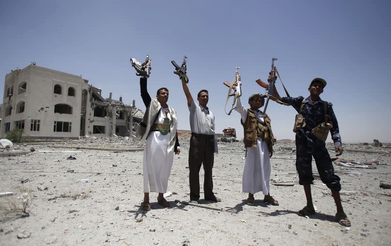 Shiite fighters, known as Houthis, hold up their weapons in Sanaa, April 2015