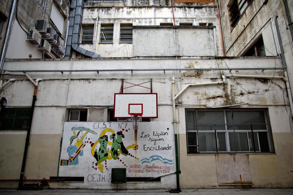 A mural with a message that reads in Spanish; "The pencils keep on writing," adorns a wall at a public school in a Buenos Aires suburb, Argentina, Wednesday, March 19, 2014. Striking teachers in the Buenos Aires province are demanding a wage increase higher than what is currently being offered by the provincial administration. The strike is in its 11th day, affecting more than 3 million students. (AP Photo/Natacha Pisarenko)