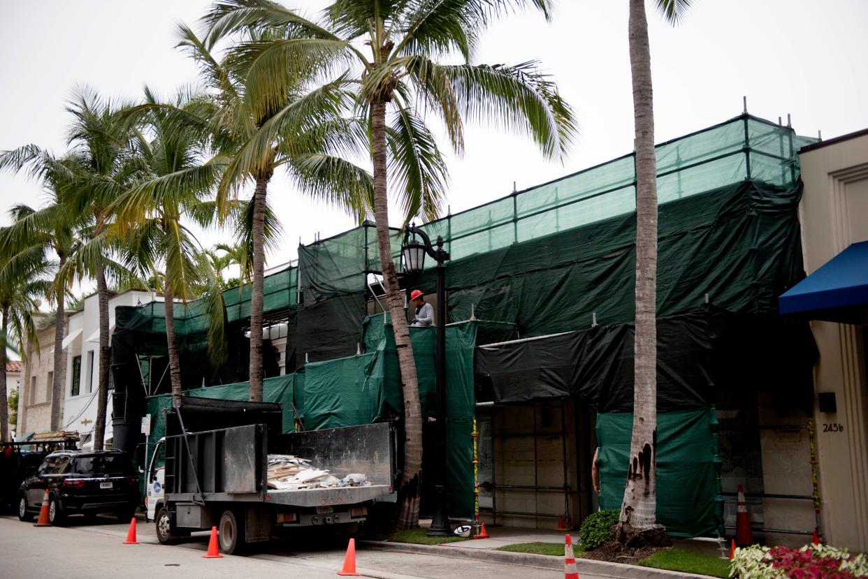 Scaffolding is set up around a building on Worth Avenue on Wednesday. Town rules require contractors to secure, store or remove all construction materials when a storm is approaching.