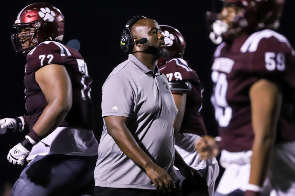 River Rouge head coach Eric Pettway shakes hands with players after a play against Belleville during the second half of Prep Kickoff Classic at Wayne State University's Tom Adams Field in Detroi on Friday, August 25, 2023.