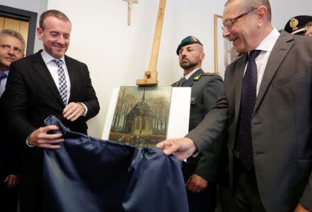 Director of Amsterdam's Van Gogh Museum Axel Ruger (L) and Naples Prosecutor Giovanni Colangelo (R) unveil a painting by the Dutch artist Vincent Van Gogh, that was stolen in Amsterdam 14 years ago, during a news conference in Naples September 30, 2016. REUTERS/Ciro De Luca