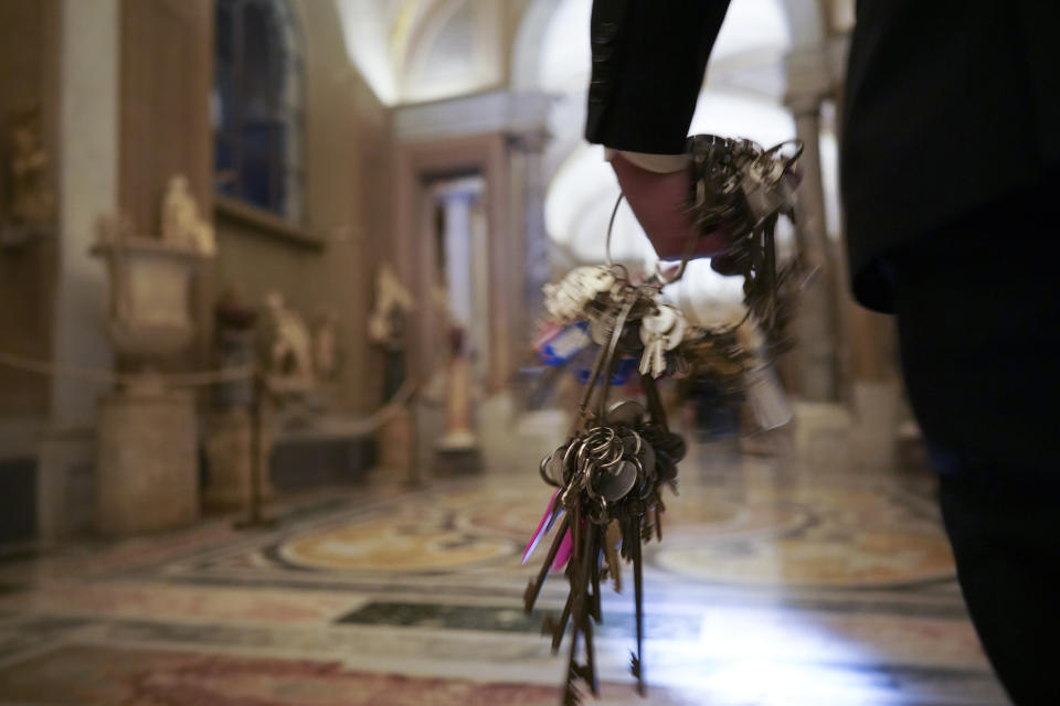 Gianni Crea, the Vatican Museums chief "Clavigero" key-keeper, holds a bunch of keys as he walks to open the museum's rooms and sections, at the Vatican, Monday, Feb. 1, 2021. Crea is the “clavigero” of the Vatican Museums, the chief key-keeper whose job begins each morning at 5 a.m., opening the doors and turning on the lights through 7 kilometers of one of the world's greatest collections of art and antiquities. The Associated Press followed Crea on his rounds the first day the museum reopened to the public, joining him in the underground “bunker” where the 2,797 keys to the Vatican treasures are kept in wall safes overnight. (AP Photo/Andrew Medichini)