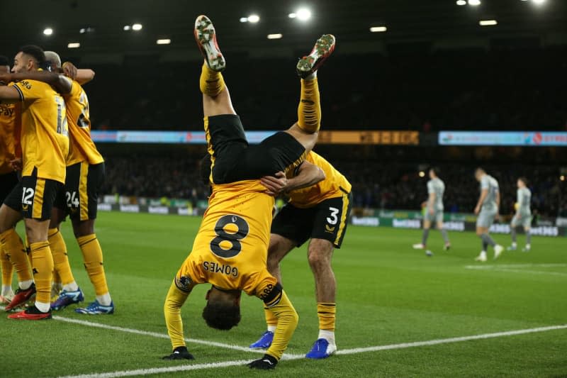 Wolverhampton Wanderers' Joao Gomes falls over while celerbating a goal during the English Premier League soccer match between Wolverhampton Wanderers and Everton at Molineux Stadium. Barrington Coombs/PA Wire/dpa