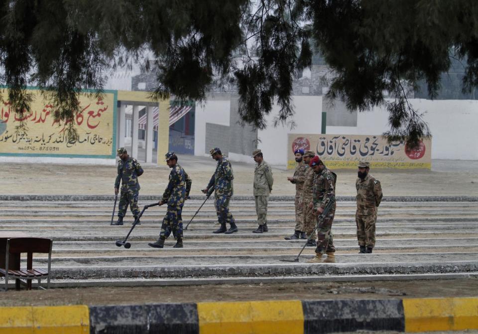 In this Wednesday, Jan. 8, 2014 photo, Pakistani soldiers scan an area with metal detectors, during a training session at the Counter IED Explosives and Munitions School, in Risalpur, Pakistan. Militants in Pakistan have become devilishly ingenious about where they plant improvised explosive devices, a type of bomb responsible for thousands of wounds and deaths in Pakistan. They’ve been found strapped to children’s bicycles, hidden inside water jugs and even hung in tree branches.(AP Photo/Anjum Naveed)