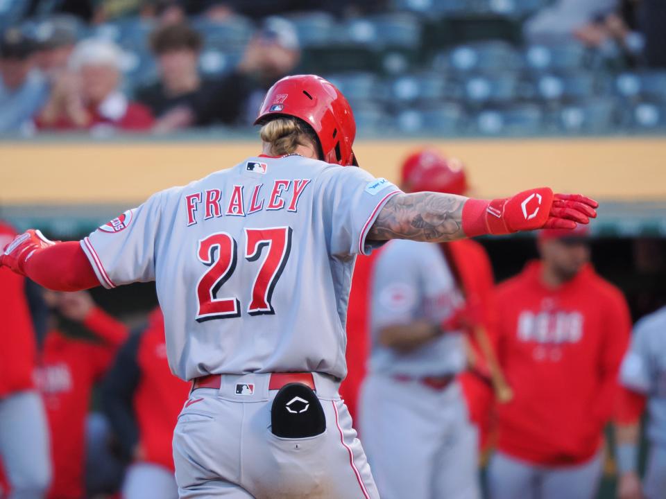 Apr 28, 2023; Oakland, California, USA; Cincinnati Reds outfielder Jake Fraley (27) gestures as he reaches home plate on a two-run home run against the Oakland Athletics during the third inning at Oakland Coliseum. Mandatory Credit: Kelley L Cox-USA TODAY Sports