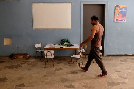 A man walks inside a house occupied by the Apacuana commune in Caracas, Venezuela November 13, 2018. Picture taken November 13, 2018. REUTERS/Marco Bello