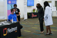 Vice President Kamala Harris talks to George Mitchell as he receives a COVID-19 vaccine at a COVID-19 pop-up center at Ebenezer Baptist Church, Friday, June 18, 2021, in Atlanta. (AP Photo/Jacquelyn Martin)