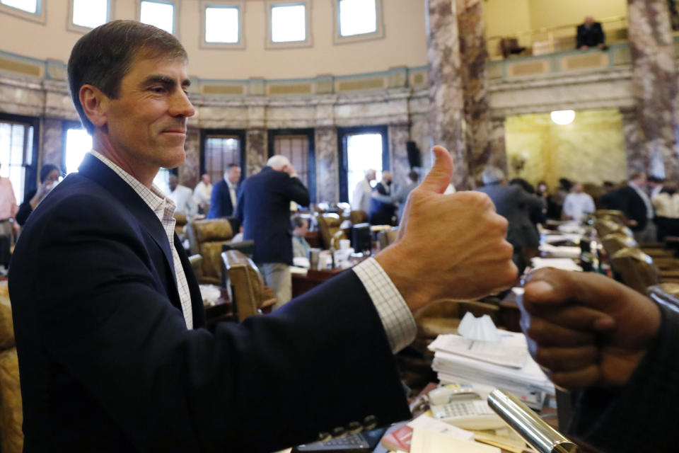 Republican Sen. Briggs Hopson, of Vicksburg, is congratulated for successfully navigating a resolution to suspend the rules and vote to change the state flag Saturday, June 27, 2020, at the Capitol in Jackson, Miss. The resolution passed and now the House and Senate are expected to pass a bill that removes the current flag and establishes a path forward to getting a new one. Gov. Tate Reeves has already said he would sign whatever flag bill the Legislature decides on. The current flag has in the canton portion of the banner the design of the Civil War-era Confederate battle flag, that has been the center of a long-simmering debate about its removal or replacement. (AP Photo/Rogelio V. Solis)