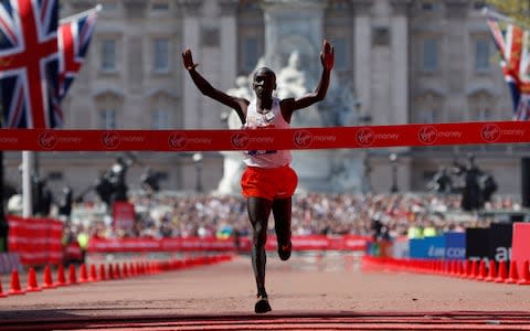 Eliud Kipchoge crosses the finish line to win - Credit: REUTERS