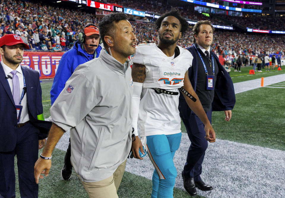 Miami Dolphins wide receiver Jaylen Waddle (17) walk out the field with the medical team after he got injured in a play against the New England Patriots during fourth quarter of an NFL football game at Gillette Stadium on Sunday, Sept. 17, 2023 in Foxborough, Ma. (David Santiago/Miami Herald via AP)