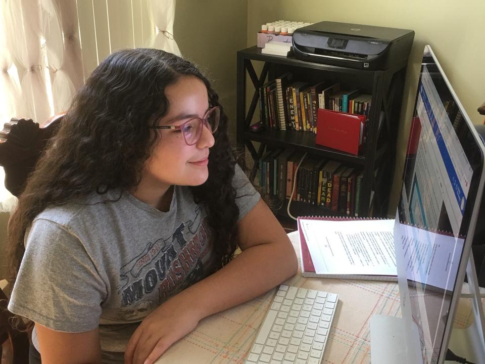 Isabela Hernandez works on a school assignment from home in Gilbert, Ariz.