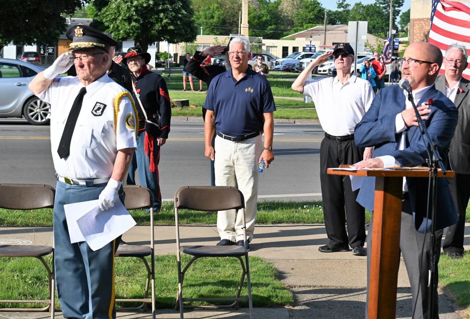 Jerry Ford on the left turned responsibilities for Memorial Day celebrations over to Joel Renshaw, at the podium, after the 2022 event.