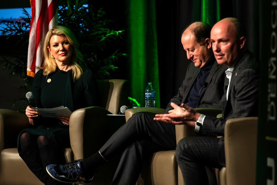 Governors Spencer Cox of Utah and Jared Polis of Colorado discuss a topic during a discussion, moderated by CSU President Amy Parsons, about how our society can learn to disagree in a way that allows us to find solutions and solve problems at Colorado State University in Fort Collins, Colo., on Wednesday, Nov. 15, 2023.