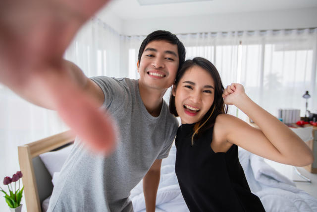Couple pose for a selfie inside their home
