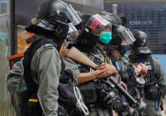 Riot Police stand guard at Central during the second day of debate on a bill that would criminalize insulting or abusing the Chinese anthem in Hong Kong, Thursday, May 28, 2020. (AP Photo/Vincent Yu)